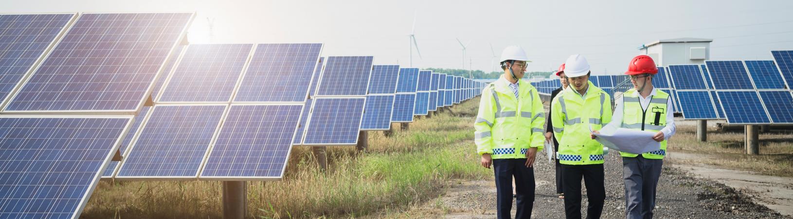 Solar panels and engineers discussing plans